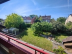Blick vom Balkon in den Garten - Großzügiges Einfamilienhaus mit Wintergarten, Doppelgarage und separat zugänglichem Einliegerbereich